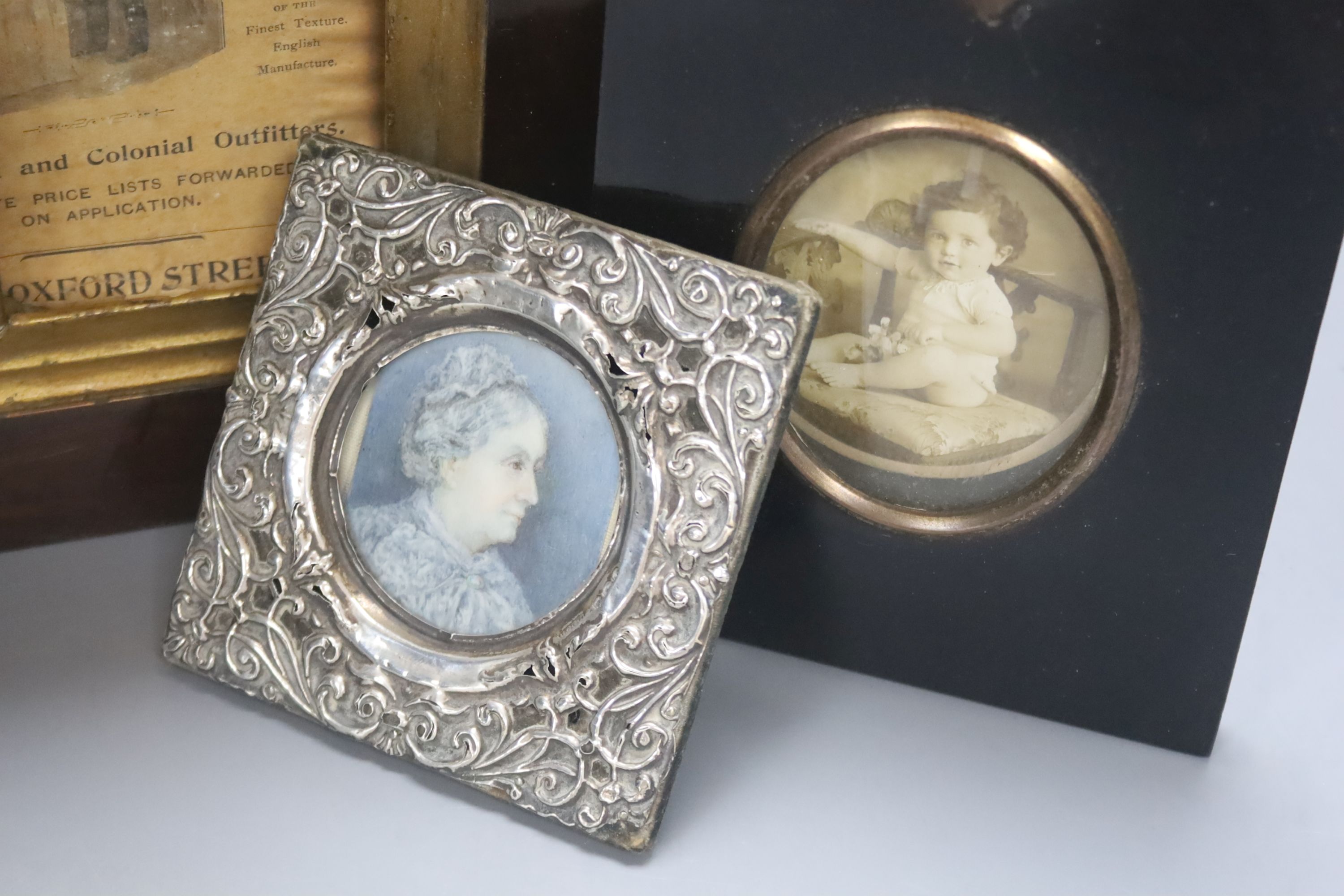 A small silver framed portrait miniature and two picture frames